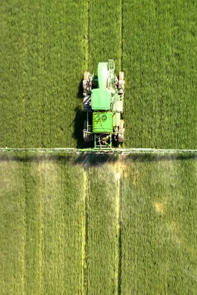 Tractor spraying chemical pesticide