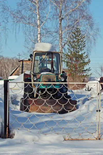 Tractor behind fence